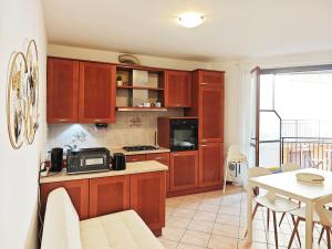 a kitchen with wooden cabinets and a table with a dining room at Route 600 in Intra +10 photos