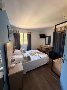 a bedroom with two beds and a mirror at Domaine de l'Oustalia in Aix-en-Provence