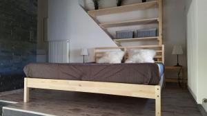 a bed with two pillows on it in a room at Joly Gîte in Les Bois +8 photos