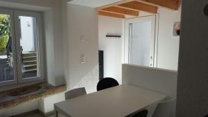 a room with a white desk and a window at Joly Gîte in Les Bois