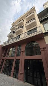 a large building with large windows on it at Benri Hotel Signature in Ho Chi Minh City