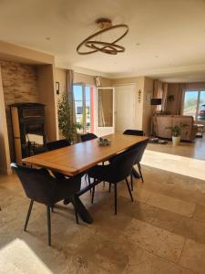 a dining room with a large wooden table and chairs at Chambre d hote in Le Tignet