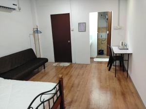 a living room with a couch and a table at HG Homestay in Kota Kinabalu