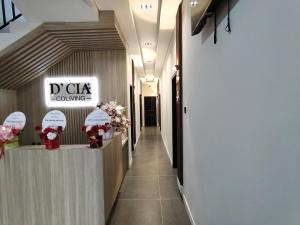 a hallway with a sign that reads dk clinic coming at D'CIA Coliving in Kejayan