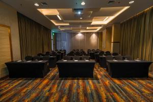 a conference room with tables and chairs in it at Somerset Central Salcedo Makati in Manila