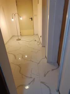 a hallway with a marble floor with a lamp on it at Mountain Apartment Vlašić Babanovac in Vlasic +23 photos