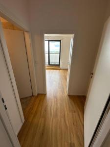 an empty room with a window and a wooden floor at StayCentralcz- Studio in Opava