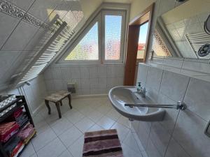 a bathroom with a sink and a window at Haus Reinsdorf in Blankenburg
