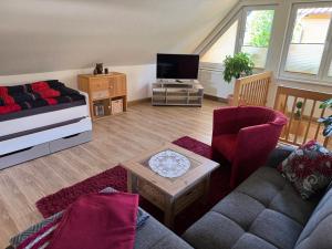 a living room with a couch and a tv at Haus Reinsdorf in Blankenburg