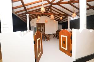 an open door in a room with a table at Shena resort in Habarana