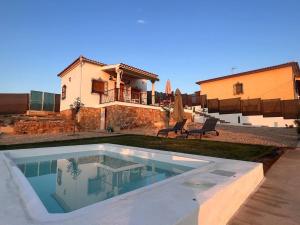 a swimming pool in front of a house at Casita La Cometa in Ruidera