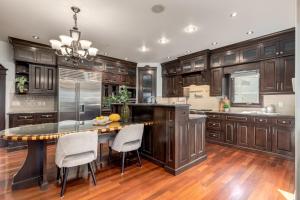 a kitchen with wooden cabinets and a table and chairs at Westmount River Inn in Calgary