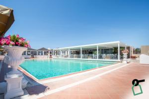 a swimming pool in front of a building at Hotiday San Felice Circeo in San Felice Circeo