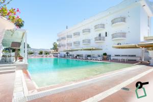 a swimming pool in front of a hotel at Hotiday San Felice Circeo in San Felice Circeo