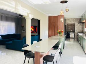a kitchen and living room with a table and chairs at No 80 At Erasmus in Polokwane