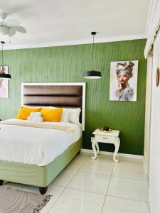 a green bedroom with a bed and a table at No 80 At Erasmus in Polokwane +149 photos