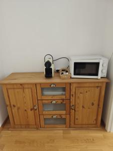 a microwave sitting on top of a wooden cabinet at Sankt Johannerhof in Ternitz