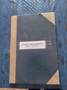 a book sitting on top of a table at Changey Inn-Kolakham in Rishop