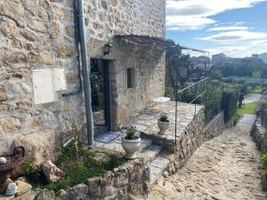 a stone building with two potted plants in front of it at Mas de lasquiers in Saint-Paul-le-Jeune +7 photos