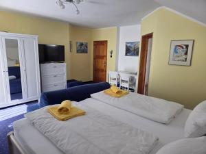 two beds in a room with towels on them at Pension Eva in Domažlice