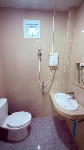 a bathroom with a toilet and a sink at The Little House in Chaloklum