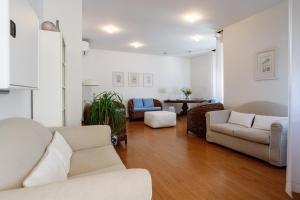 a living room with two couches and a table at Hotel Telenia in Lido di Jesolo