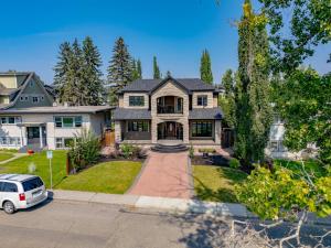 a house with a car parked in the driveway at Westmount River Inn in Calgary