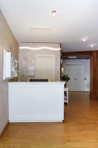 an office lobby with a white reception counter at Hotel Telenia in Lido di Jesolo