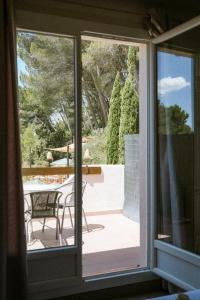 a view of a patio through a sliding glass door at Domaine de l'Oustalia in Aix-en-Provence