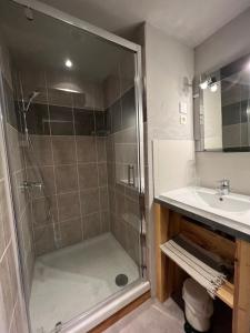 a bathroom with a shower and a sink at La compagnie du bourg in Le Châtelard