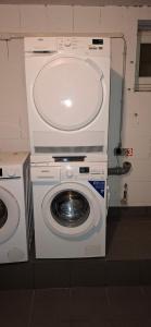 a washing machine and a washer in a room at Monteurwohnungwgapartment In 50129 in Bergheim