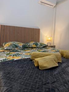 a bedroom with two beds with pillows on them at Coeur SAINT-PAUL in Saint-Paul