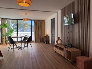 a living room with a table and chairs and a dining room at Coeur SAINT-PAUL in Saint-Paul