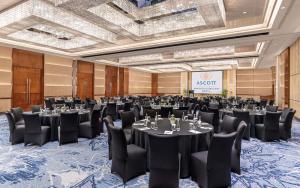 a conference room with tables and chairs and a screen at Ascott Bonifacio Global City Manila in Manila +17 photos