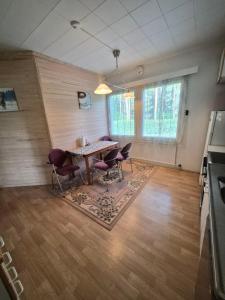 a living room with a table and chairs in it at MiniMani House with Sauna in Sorsakoski +14 photos