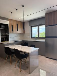 a kitchen with a table and chairs and a window at IOLENA Two Bedroom SEAVIEW APT in Pyla