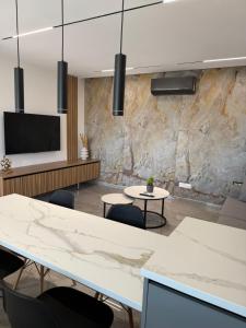 a conference room with two tables and a flat screen tv at IOLENA Two Bedroom SEAVIEW APT in Pyla