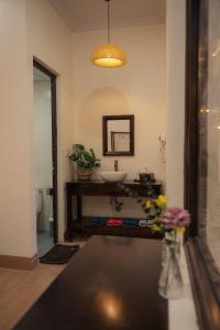 a bathroom with a sink and a mirror at Tan Ca Home & Studio Ninh Bình in Kỳ Vĩ