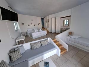 a living room with a couch and a bed at Solaris in Chora Folegandros +49 photos