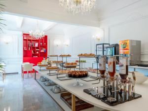a buffet of food on a table in a kitchen at B&B HOTEL Pesaro Des Bains in Pesaro +22 photos