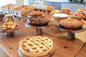 a table with pies and other pastries on plates at B&B HOTEL Expo Verona Villafranca in Villafranca di Verona +27 photos