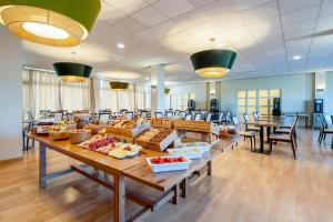 a large room with tables with food on them at B&B HOTEL Expo Verona Villafranca in Villafranca di Verona