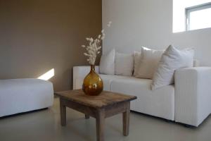 a vase on a coffee table in a living room at Grange rénovée - Calme et Vue sur les volcans in Saint-Just-près-Brioude