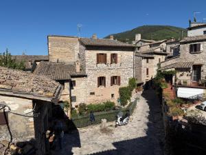 a view of a village with stone buildings at Casa Picicio in Assisi