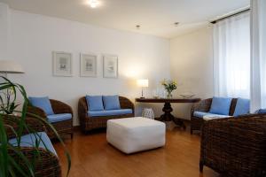 a living room with wicker chairs and a table at Hotel Telenia in Lido di Jesolo