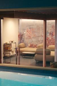 a living room with a couch and a painting on the wall at Albergo Da Carmine in Castellabate
