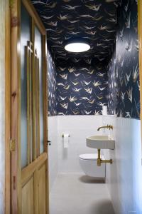 a bathroom with a toilet and a sink in it at Alazne Enea in Bermeo +95 photos