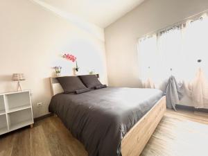 a bedroom with a large bed and a window at Le Cosy Industriel in Le Puy-en-Velay