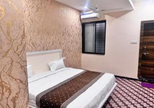 a bedroom with a large bed in a room at Shree ji Hotel and Resort in Ujjain +22 photos