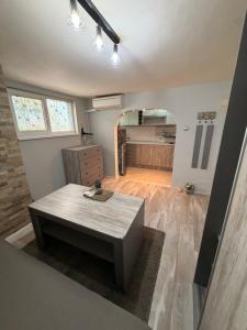 a living room with a table and a kitchen at Catherdral Apartments with Parking in Varna City